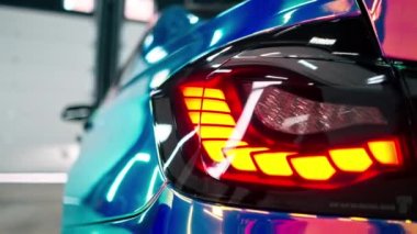 Bumelion renkli filmdeki lüks bir arabanın arka farının yakın çekimi araba detaylandırması sürecinde.