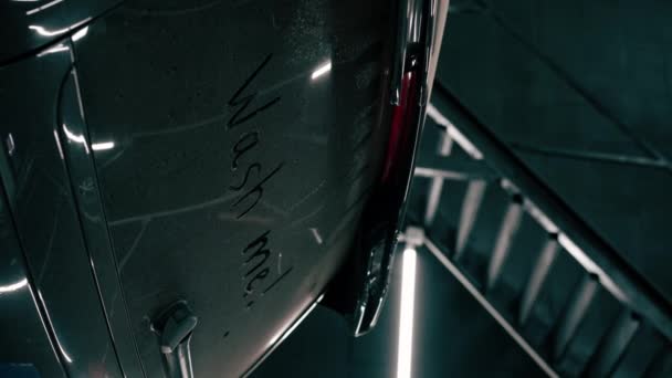 Zbliżenie Mycia Mnie Znak Brudnej Tylnej Szybie Luksusowego Czarnego Samochodu — Wideo stockowe