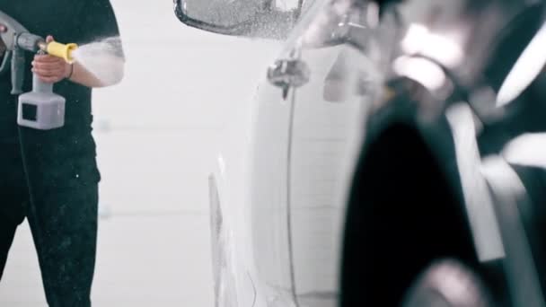 Man Biltvätt Anställd Tillämpar Biltvätt Tvättmedel Svart Lyxbil Med Hjälp — Stockvideo