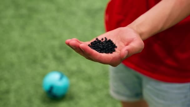 Close Hand Holding Football Synthetic Grass Rubber Texture — Stock Video