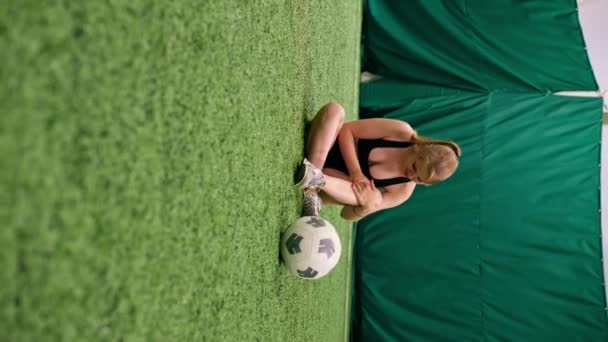 Вертикальное Видео Юная Футболистка Повредила Ногу Время Тренировочного Матча Сидя — стоковое видео