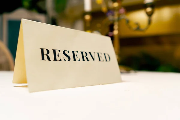 Close-up of reservation sign reserved standing on a table in an expensive luxury Italian restaurant