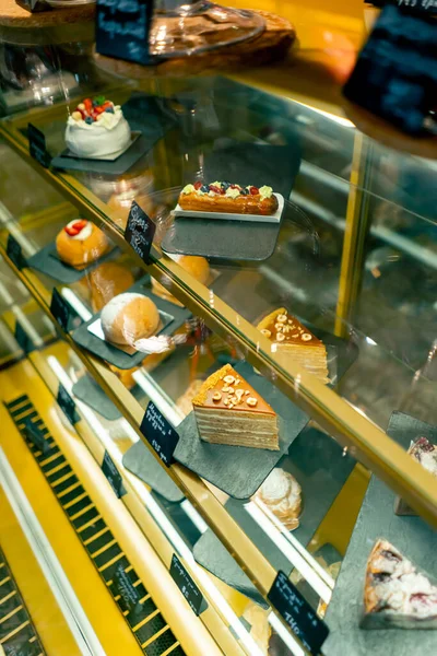 close-up of refrigerators with various desserts in an Italian restaurant concept of love for cakes and pies