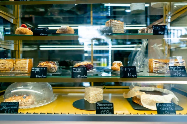 close-up of refrigerators with various desserts in an Italian restaurant concept of love for cakes and pies