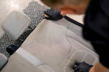 Oto yıkama işçisinin yakın plan fotoğrafı. Lüks bir arabadan haç fırçalama işlemi sırasında çıkarılmış.