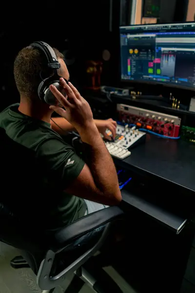 Male Sound Engineer Wearing Headphones Sits Mixing Desk His Back — Stock Photo, Image