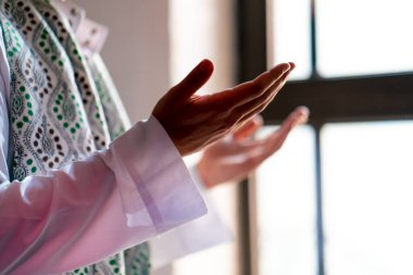 Müslüman bir adamın Ramazan 'da bir İslam tapınağında diz çöküp namaz kıldığı yakın çekim.