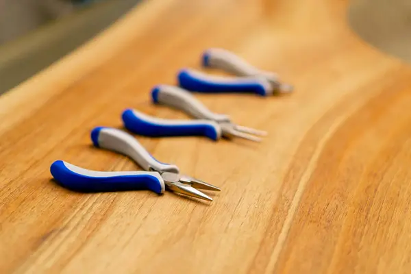 close-up working tools pliers on the table before starting the production craft jewelry