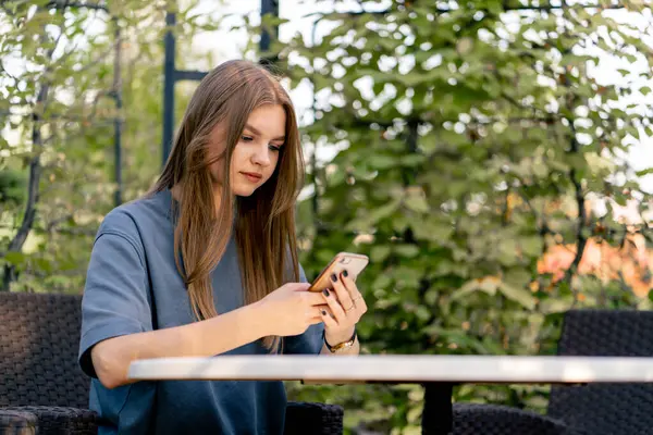 Sad Young Girl Sits Table Garden Looks Thoughtfully Phone Her — Stock Photo, Image