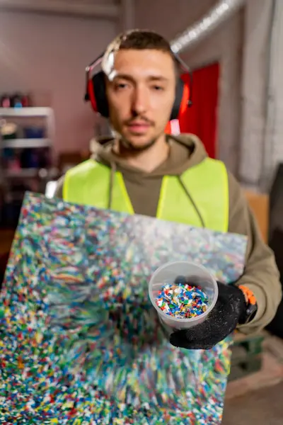 Factory Employee Holds Painting Made Shredded Plastic Bottle Caps Waste — Stock Photo, Image