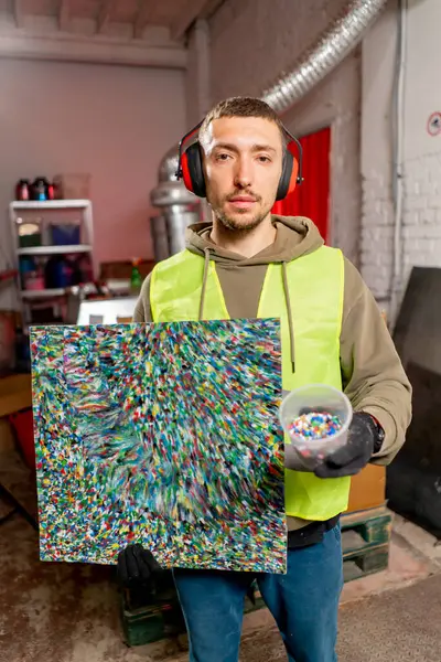 Factory Employee Holds Painting Made Shredded Plastic Bottle Caps Waste — Stock Photo, Image