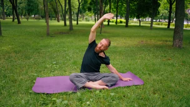 Handsome Bearded Man Meditating Park Practicing Yoga Doing Stretching Exercises — Stock Video
