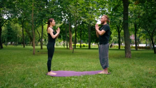 Couple Practicing Yoga Outdoors City Park Doing Meditation Exercises Namaste — Stock Video