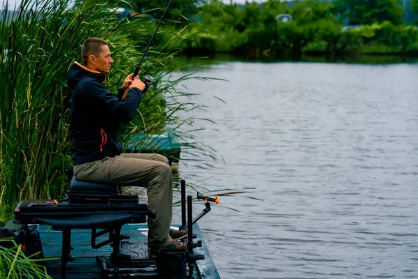 Fisherman Fishing Rod Spinning Rod Professional Tools Sitting River Bank — Stock Photo, Image
