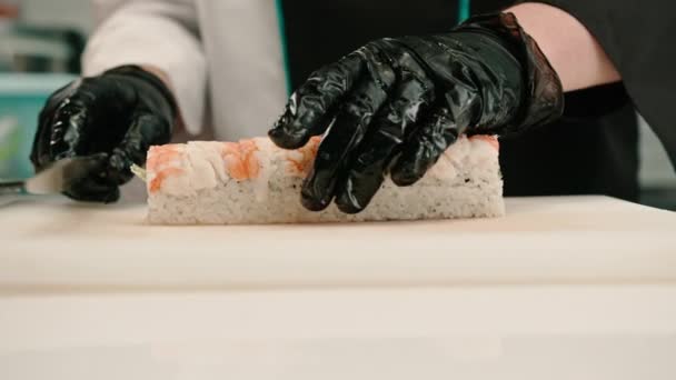 Zbliżenie Sushi Człowiek Czarny Rękawiczki Cięcie California Rolka Biały Kuchnia — Wideo stockowe