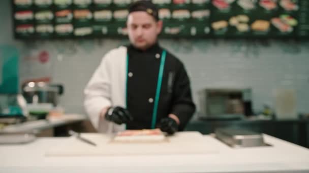 Sushi Chef Prepares Cream Cheese Salmon Cucumber White Kitchen Board — Stock Video