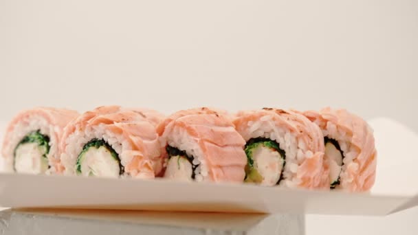 Close Roll Baked Salmon Cucumber Cheese White Background Sushi Delivery — Stok Video