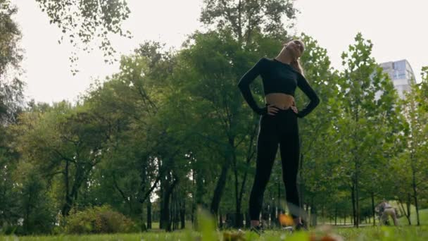 Sportowa Dziewczyna Rozciąga Ramiona Szyję Podczas Porannych Ćwiczeń Parku Słuchając — Wideo stockowe