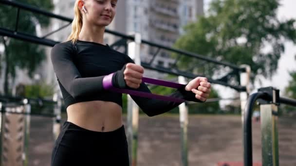 Close Girl Performing Exercises Elastic Bands Strengthen Her Arm Muscles — Stock Video