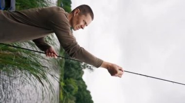 Dikey video Uçan balıkçı erkek elleri olta ya da elle besleyici serbest stil metodu