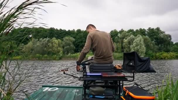 Fisherman Fishing Rod Spinning Professional Tools Sitting River Bank Rear — Stock Video