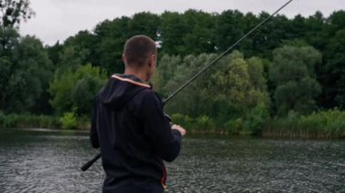 Balıkçı oltayla ya da dönen aletlerle nehir kıyısında dikiz aynasından balık tutar.