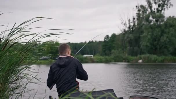 Fisherman Fishing Rod Spinning Professional Tools Sitting River Bank Rear — Stock Video