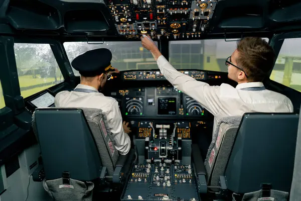 Airplane cabin Pilots check airplane electronics by pressing buttons Passenger airliner preparation takeoff rear view flight simulator
