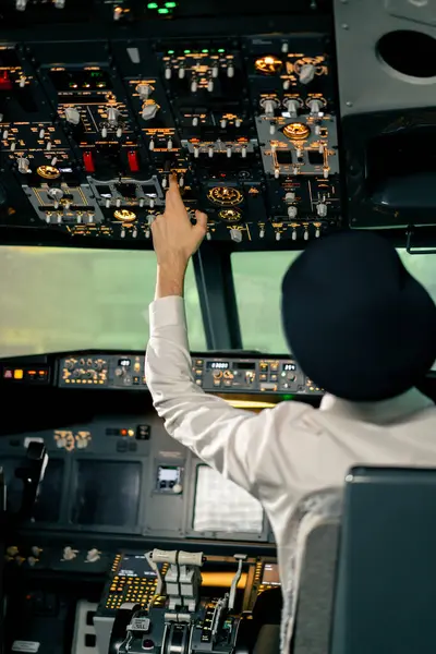 Airplane cabin The pilot checks the plane\'s electronics by pressing the buttons Preparing passenger liner for takeoff
