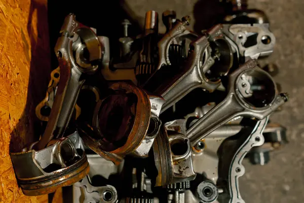 close up pistons and connecting rod on the table disassembled engine repairing an engine