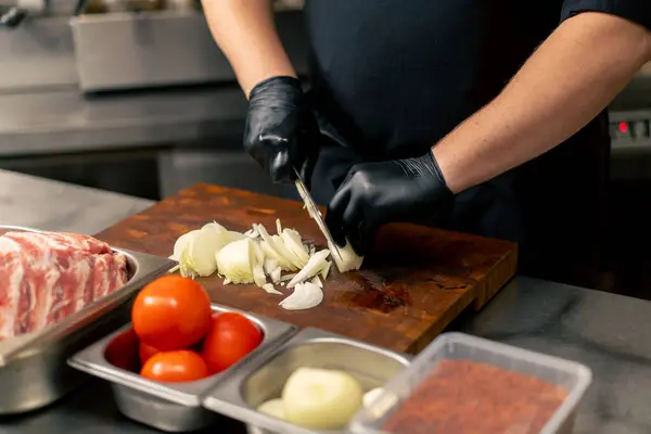 Close Professional Kitchen Chef Black Uniform Chops Onions Board — Stock Photo, Image