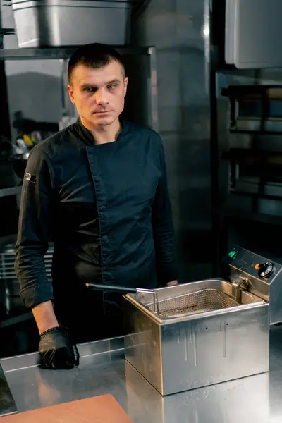 Chef Kitchen Black Jacket Stands Cooker Looks Thoughtfully — Stock Photo, Image