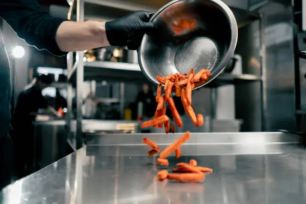 close-up of sweet potato fries spilled onto the cooks table before cooking