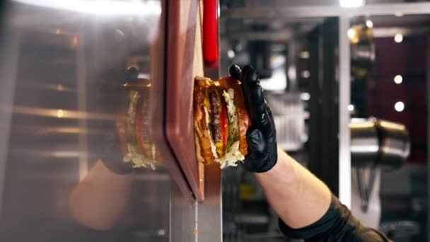 레스토랑에서 비디오 클로즈업 기성품 햄버거에 절반을 — 비디오
