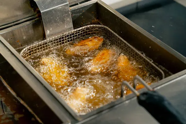 Profesyonel Bir Mutfakta Yakın Plan Çekimde Tavuk Kanatlarını Fritözde Kızartıyorum — Stok fotoğraf