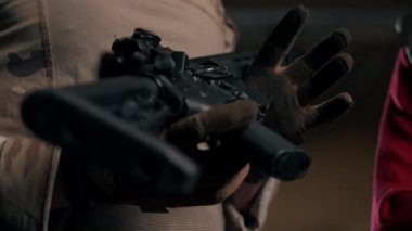 Profesyonel bir atış poligonunda askeri eğitimci bir kıza NATO silahlarını nasıl kullanacağını söyler.