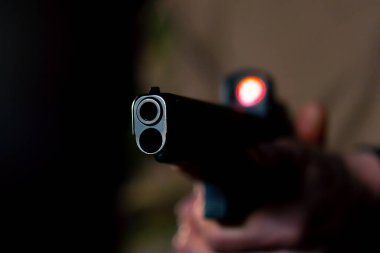 Profesyonel bir atış talimine yakın cephaneli askeri eğitimci silahla nişan alır.