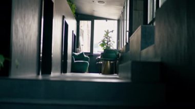 Şehir restoranı, koyu duvarlı, alüminyum kaplamalı oturma alanı olan minimalist bir mekan.