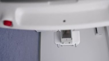 Beyaz ofisteki modern bir klinikte dikey video, florografi görüntülerine hazırlık, hastaların güvenli bir şekilde incelenmesi için son teknolojiler