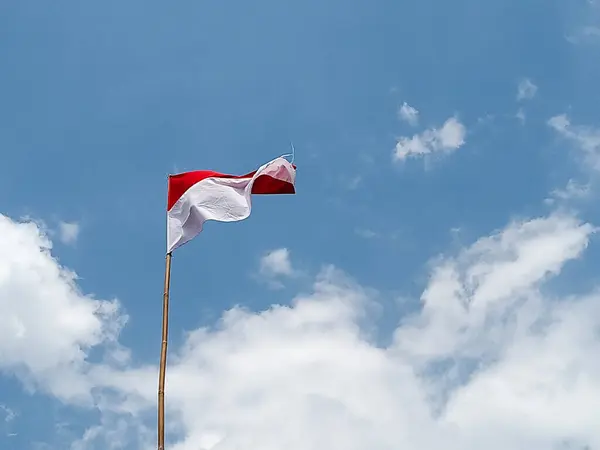 stock image Indonesian flag against a blue sky background