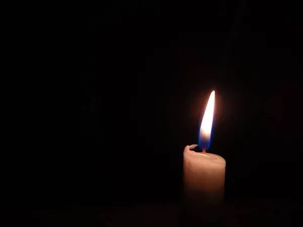 Karanlıkta yanan beyaz bir mum