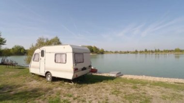 Showing around a tiny travel trailer parking at a lake
