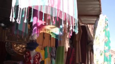 Bazaar clothing and carpets hanging in Morocco Marrakech