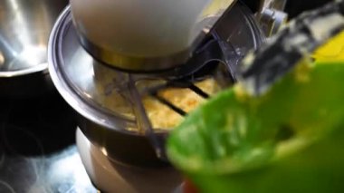 Dropping butter onto the side of egg beater machine