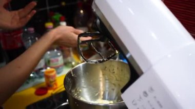 Starting an egg beating stand mixer by folding down