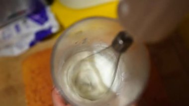 Close up of mixing white cream with a hand blender