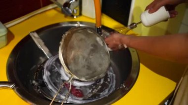 Washing up kitchen utensils after cooking