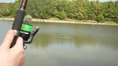 Fishing reel spinning as pulling a fish in