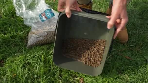 Showing Shaking Bucket Wet Fishing Pellets — Video Stock