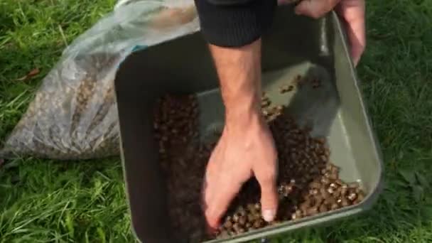 Angler Mixing Wet Pellets One Hand — Stock Video